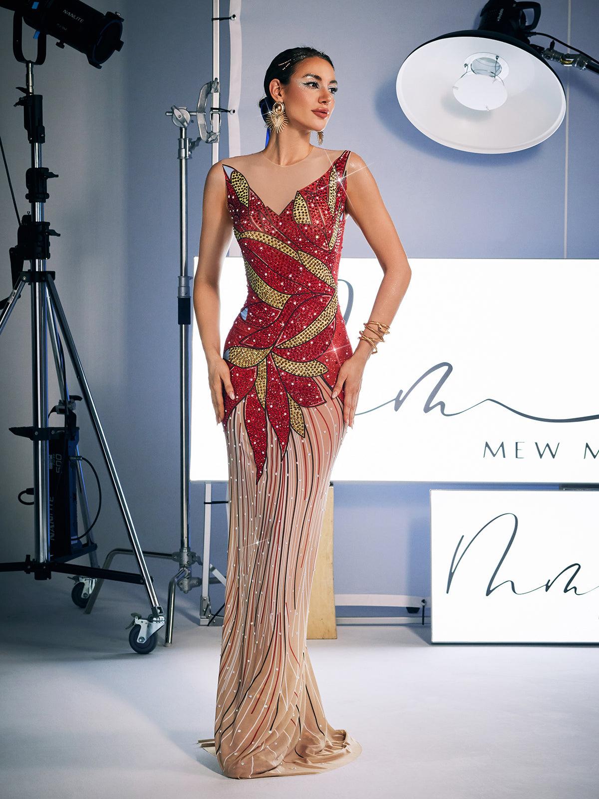 A stunning model wears the Leofric Crystal Pearl Embellished Maxi Dress, a luxurious red maxi dress adorned with crystals and pearls, perfect for special occasions.