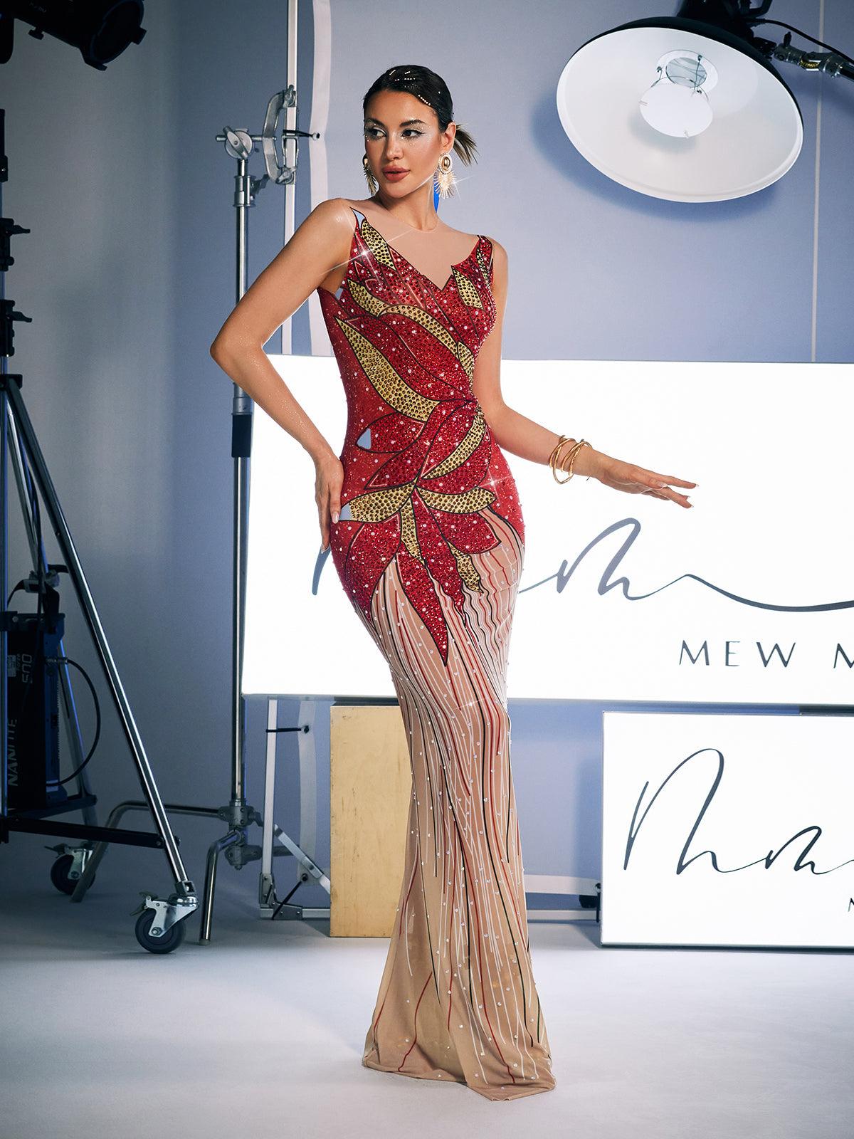 A stunning model wears the Leofric Crystal Pearl Embellished Maxi Dress, a luxurious red maxi dress adorned with crystals and pearls, perfect for special occasions.